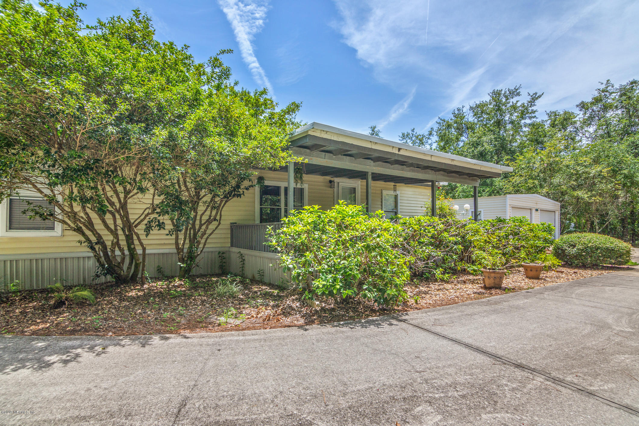 1665 Scott Road St. Johns, FL 32259 - Photo 8 of 54 front view of a house with a yard and potted plants