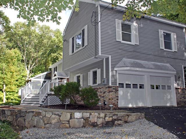 34 Rock Ridge Road Newtown, CT 06470 - Photo 1 of 1 a front view of a house with a yard