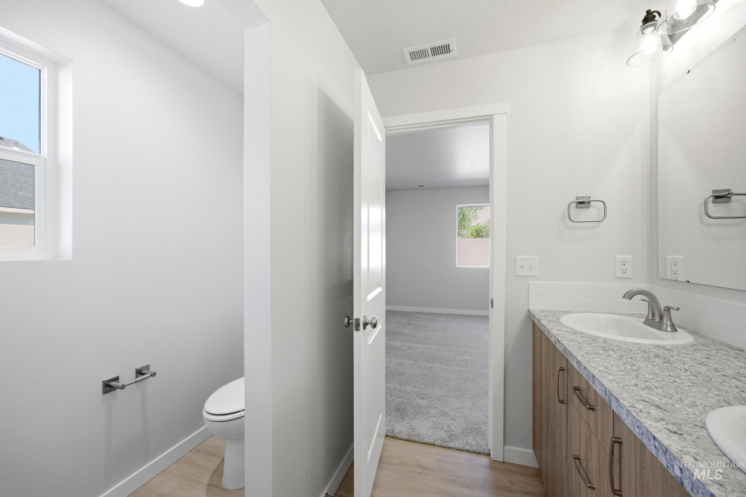 13298 Bank Street Caldwell, ID 83607 - Photo 14 of 23 Double vanity with undermount sinks and wood-finish cabinetry