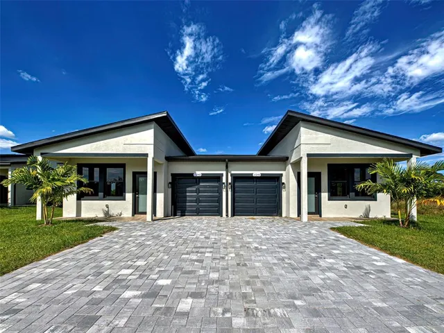 a view of a house with a yard and porch