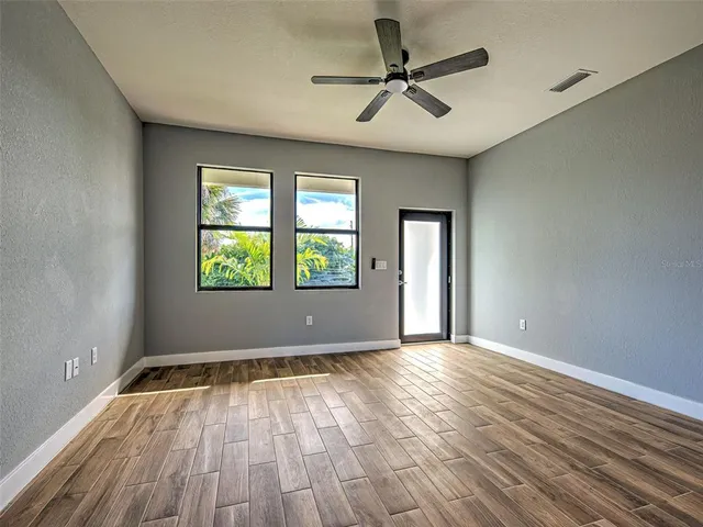 wooden floor in an empty room with a window