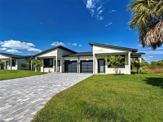 a view of a house with a yard and porch