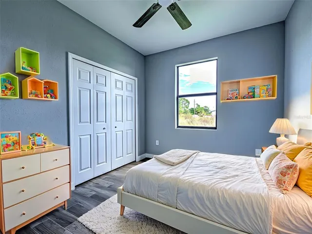 a bedroom with a bed and a window