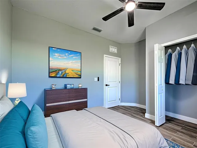 a bedroom with a bed and ceiling fan