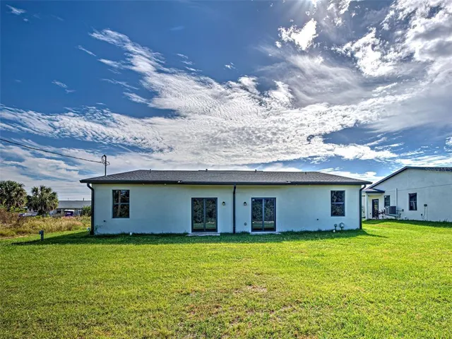 a view of a house with a backyard