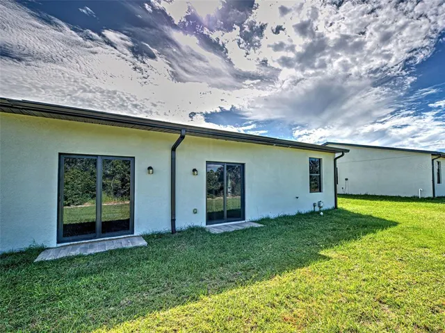 a backyard of a house with lots of green space