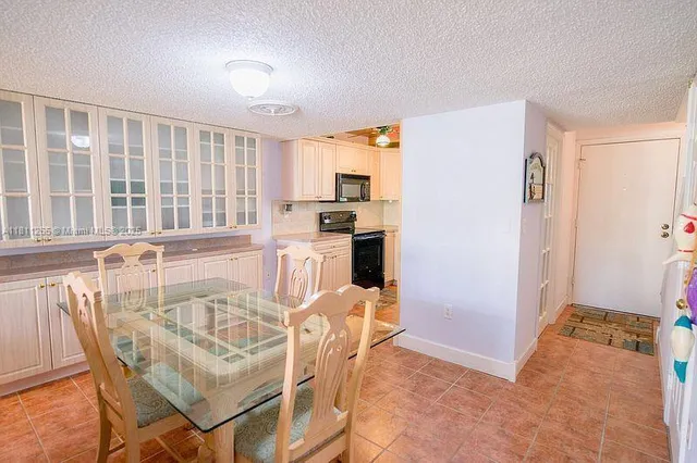 a view of a dining room with furniture and a kitchen