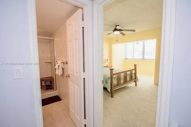 a bathroom with a tub and a hallway