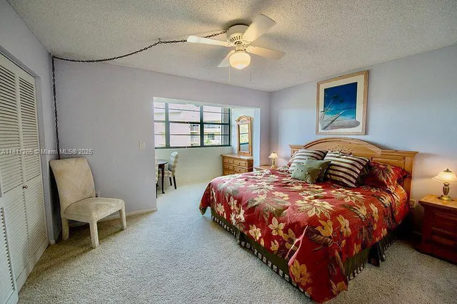 a bedroom with a bed and lamp