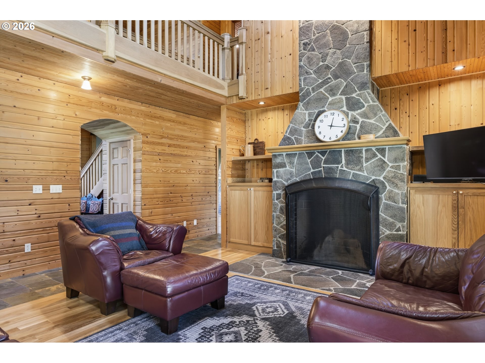 17765 Monnier Road Northeast Hubbard, OR 97032 - Photo 12 of 48 a living room with furniture a fireplace and a flat screen tv