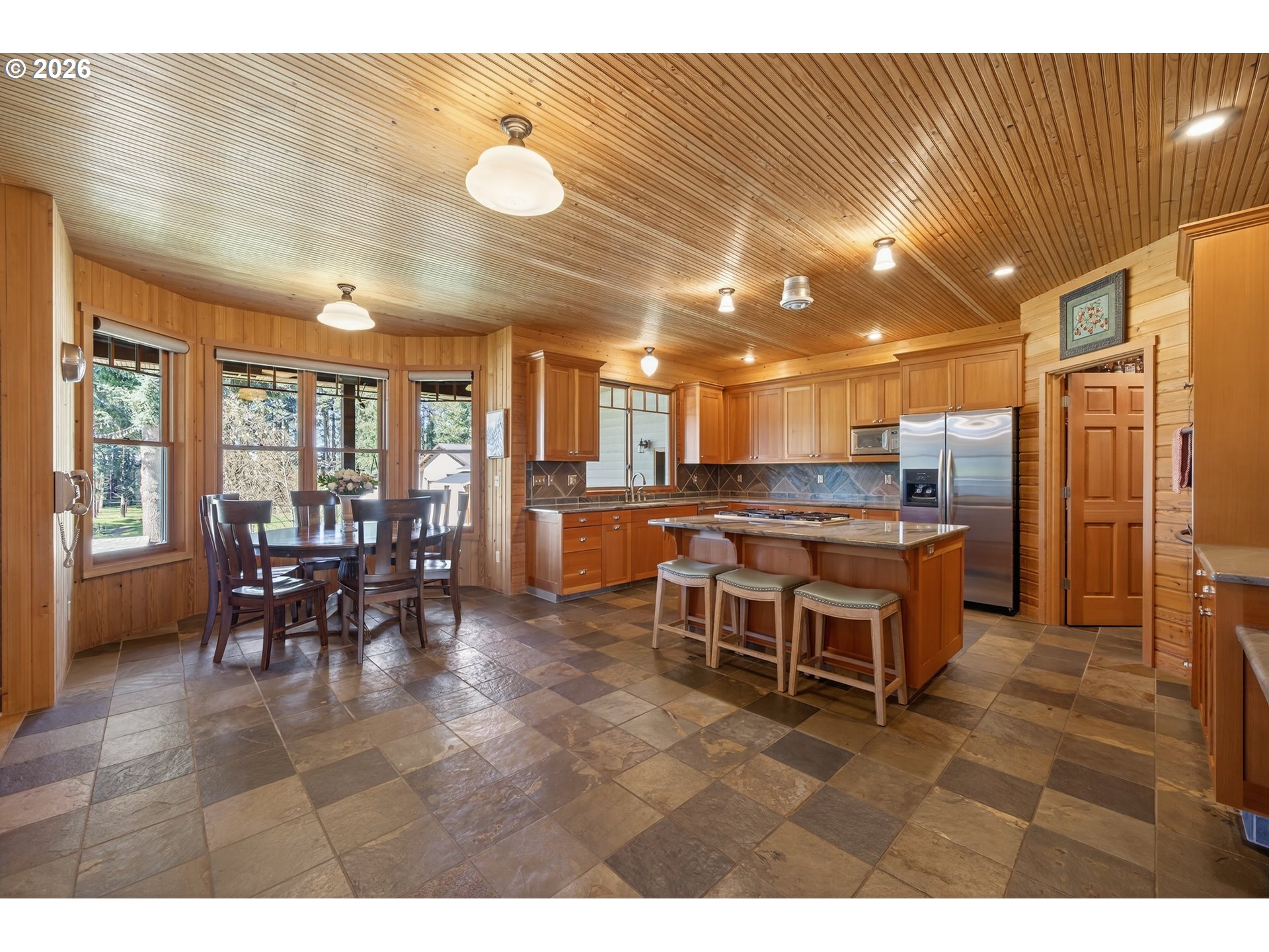 17765 Monnier Road Northeast Hubbard, OR 97032 - Photo 14 of 48 a open kitchen with a table and chairs