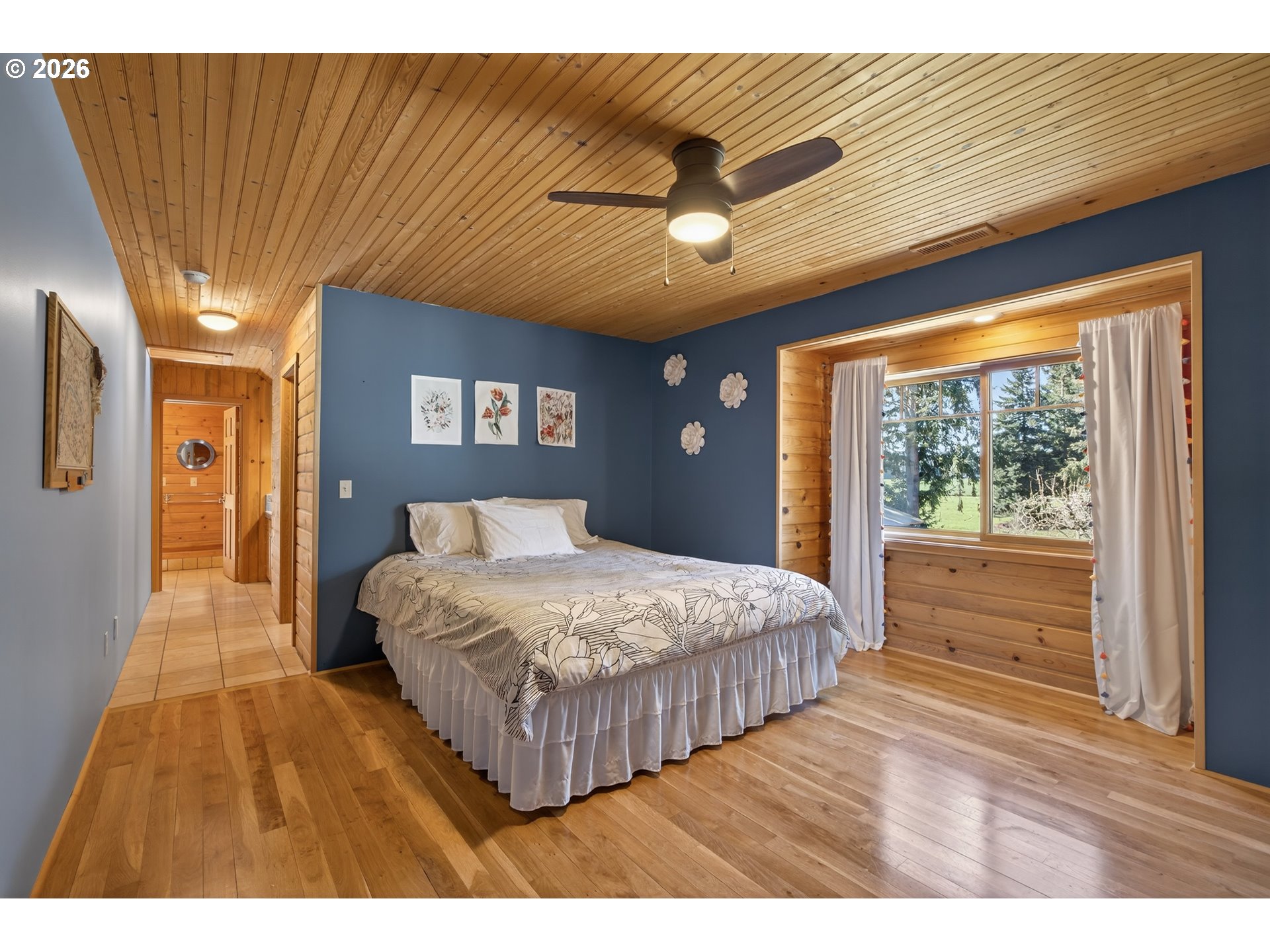 17765 Monnier Road Northeast Hubbard, OR 97032 - Photo 25 of 48 a bedroom with a large bed and a large window