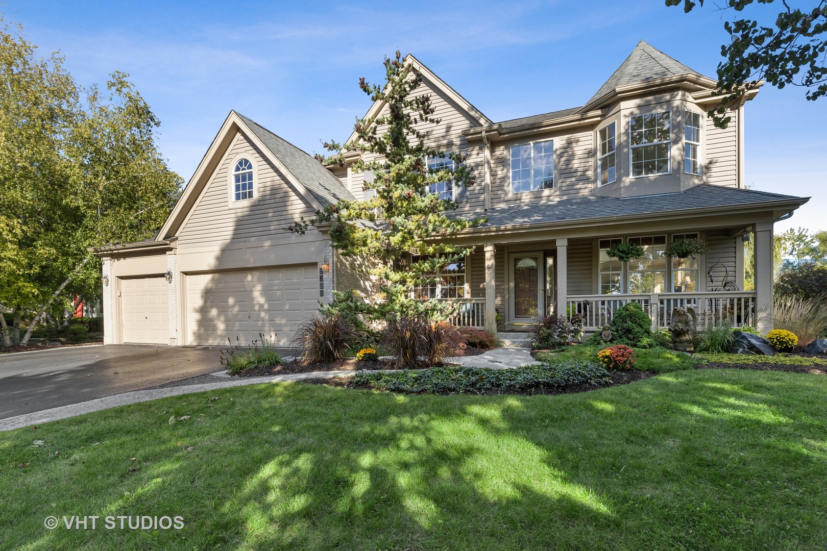 a front view of a house with a yard and porch