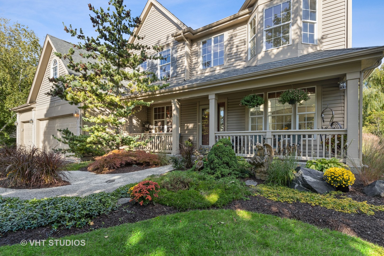 6265 Murifield Drive Gurnee, IL 60031 - Photo 2 of 30 a view of a house with potted plants and a large tree