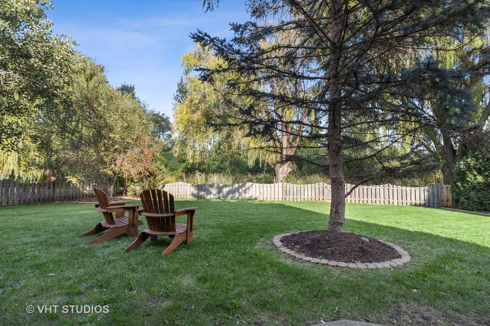 6265 Murifield Drive Gurnee, IL 60031 - Photo 25 of 30 a table and chair sitting in the grass near a tree