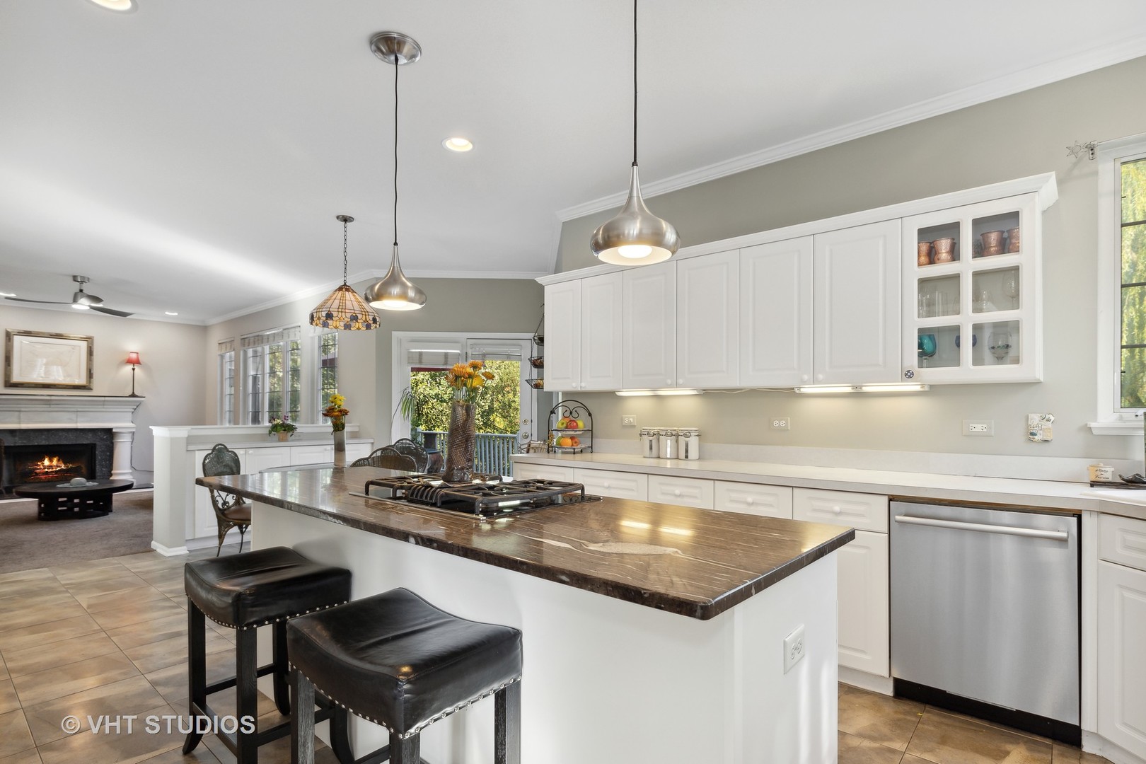 6265 Murifield Drive Gurnee, IL 60031 - Photo 6 of 30 a kitchen with a sink dishwasher a stove a dining table and chairs with wooden floor