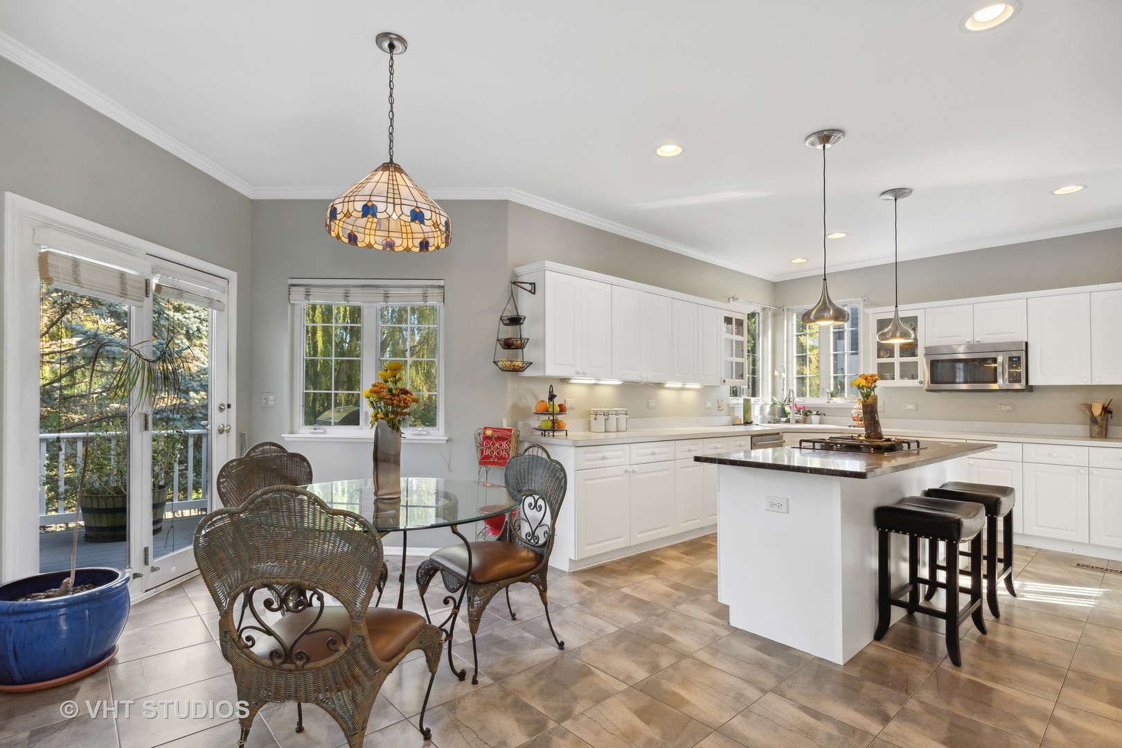 6265 Murifield Drive Gurnee, IL 60031 - Photo 9 of 30 a kitchen with granite countertop kitchen island dining table and a large window