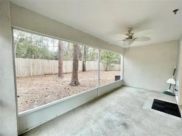 a view of room with window and a ceiling fan