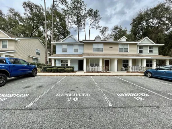 a front view of a residential apartment building with a yard