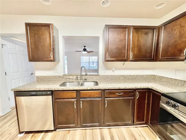 a kitchen with granite countertop a sink and cabinets