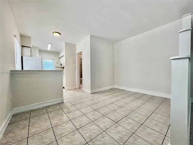 a view of a refrigerator and window in a room