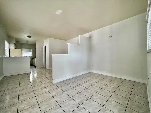 a view of a kitchen with white cabinets