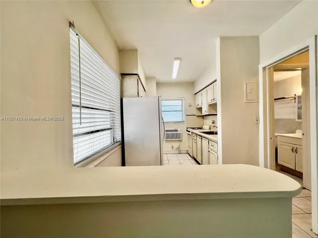 a kitchen with stainless steel appliances kitchen island sink refrigerator and stove