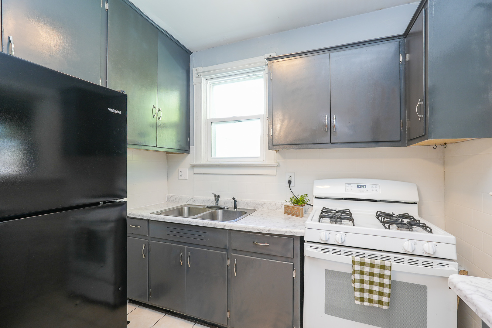 264 West 3rd Street Manteno, IL 60950 - Photo 16 of 29 a kitchen with a sink a stove and a refrigerator