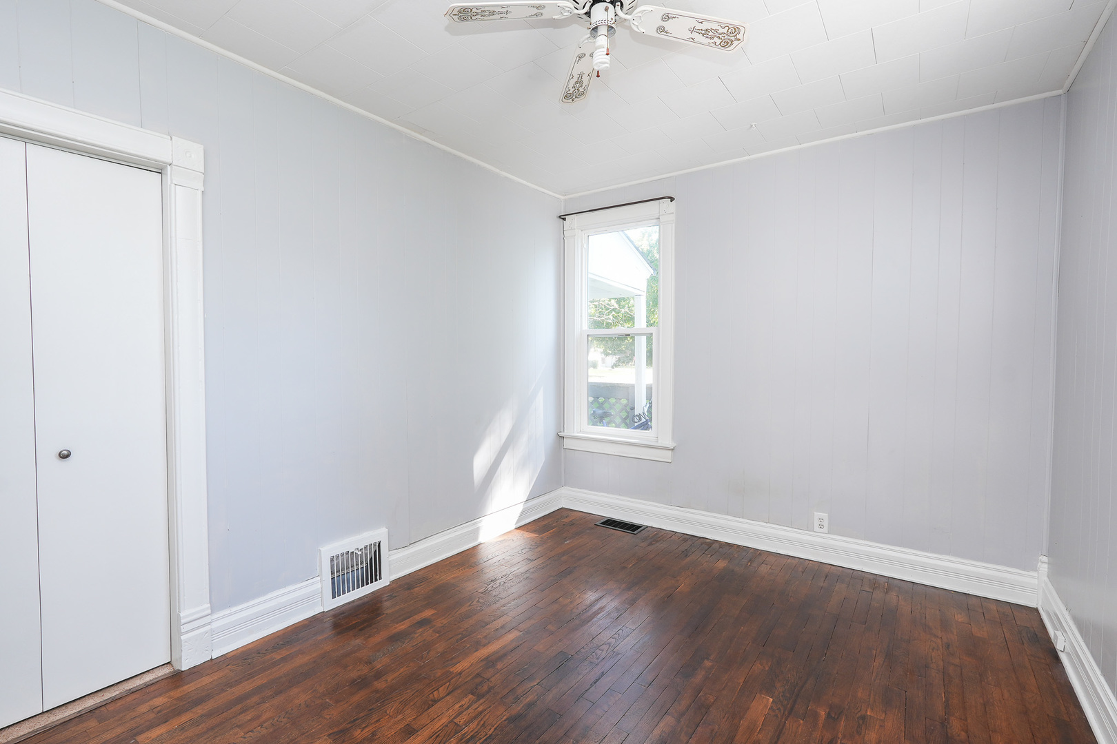 264 West 3rd Street Manteno, IL 60950 - Photo 22 of 29 an empty room with wooden floor and windows