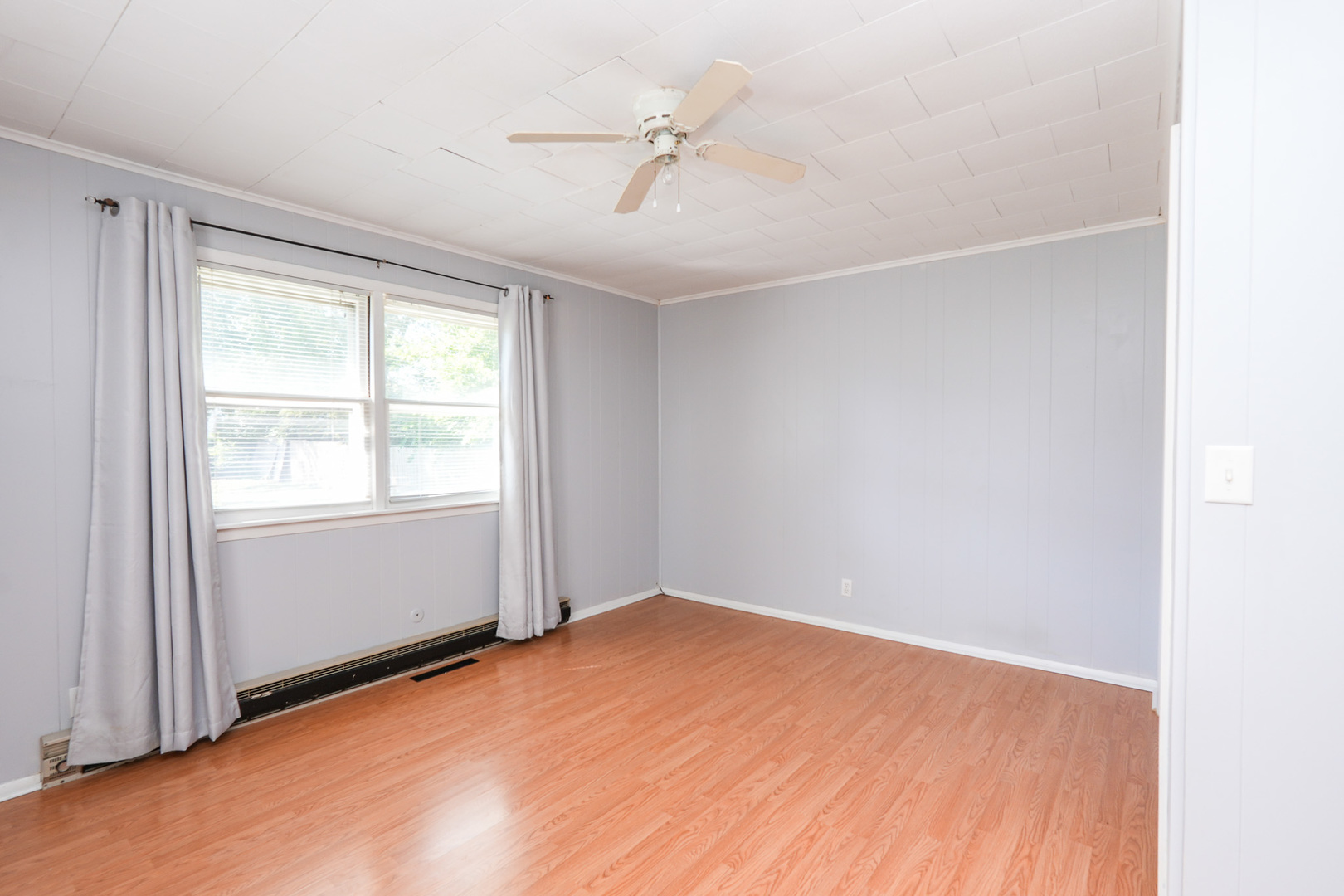 264 West 3rd Street Manteno, IL 60950 - Photo 23 of 29 an empty room with a window and a ceiling fan