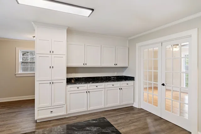 a kitchen with kitchen island granite countertop a sink cabinets and stainless steel appliances