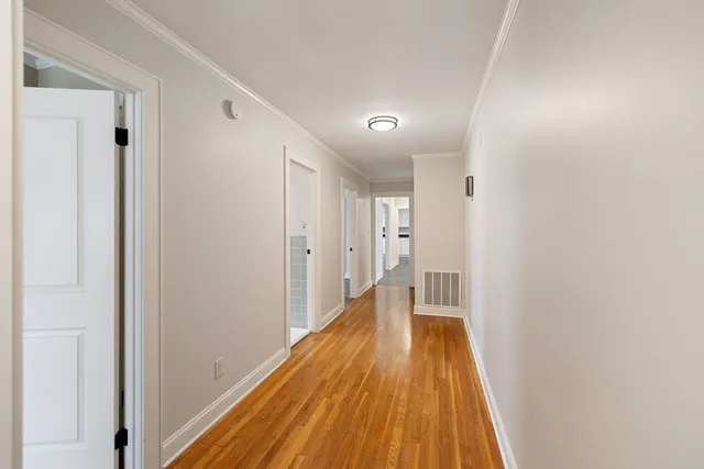 a view of an empty room with window and a ceiling fan