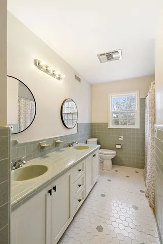 a view of a hallway with wooden cabinets