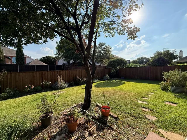 a view of backyard with trampoline