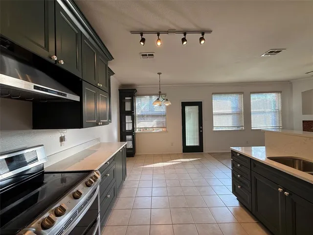 a kitchen with a stove and a refrigerator
