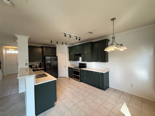 a kitchen with granite countertop a sink dishwasher stove and oven with wooden floor