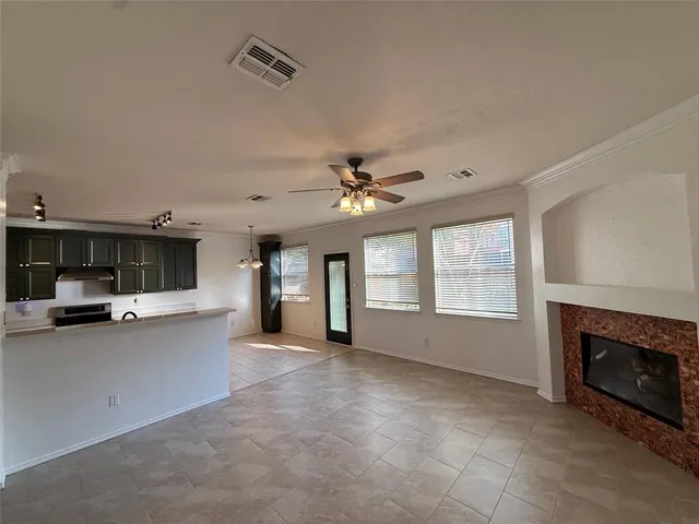 a view of a kitchen with a sink and a fireplace