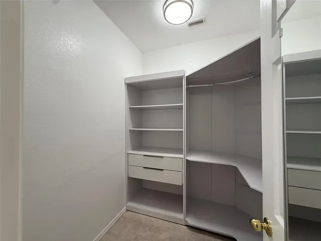 a view of an empty walk in closet