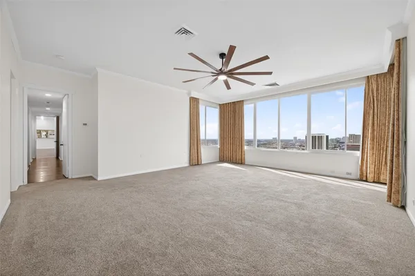 a view of a livingroom with a ceiling fan and window