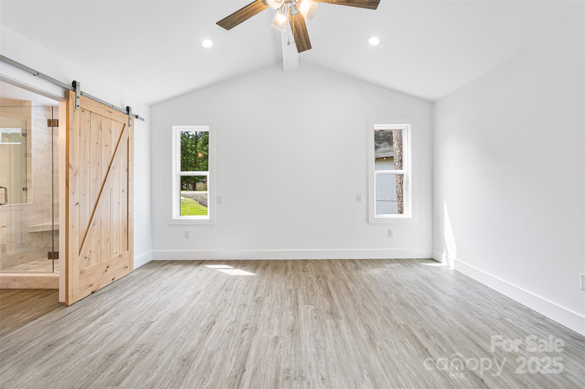 2027 Marquesas Avenue Tega Cay, SC 29708 - Photo 14 of 46 an empty room with wooden floor and windows