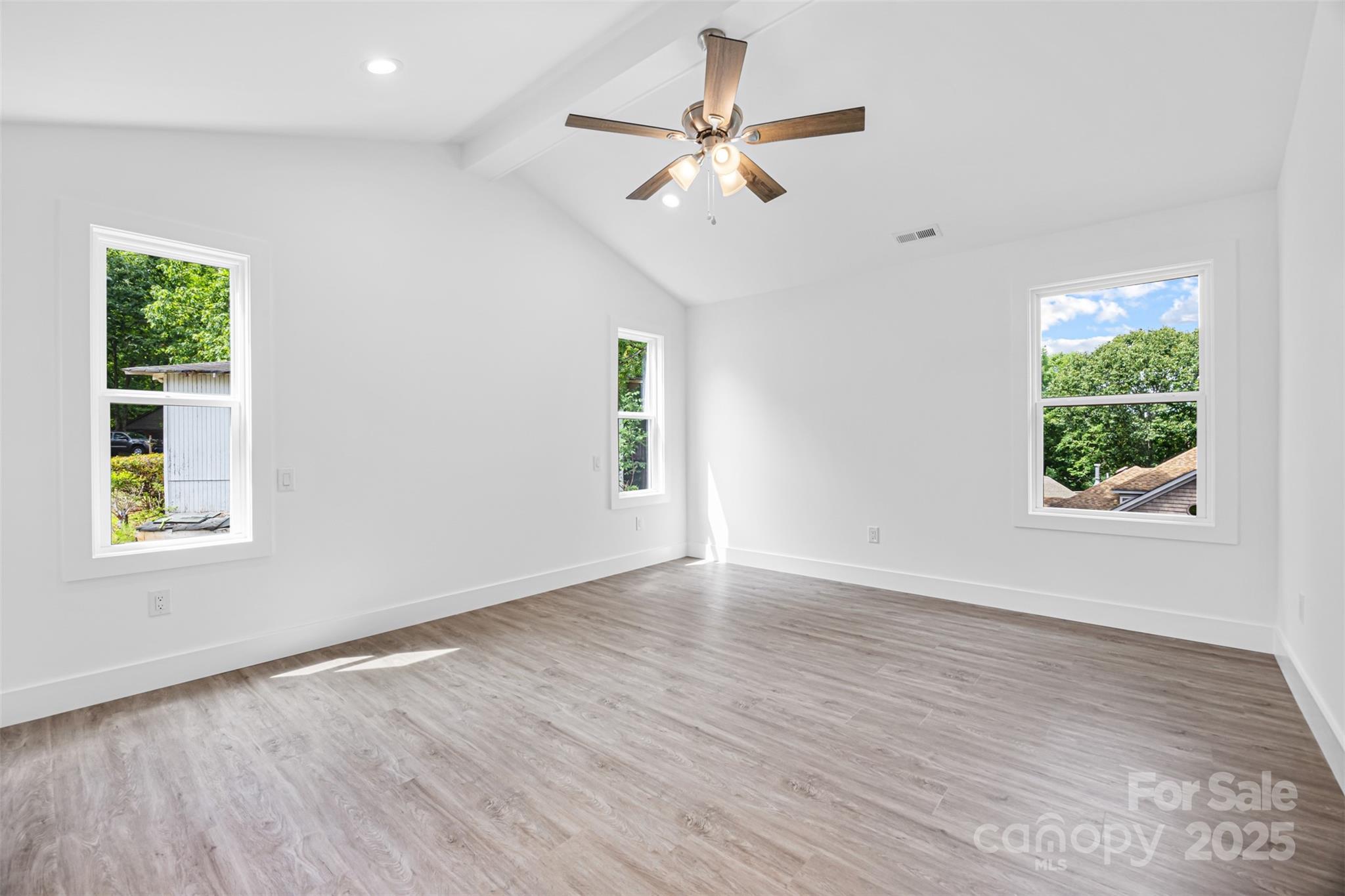 2027 Marquesas Avenue Tega Cay, SC 29708 - Photo 15 of 46 an empty room with wooden floor fan and windows