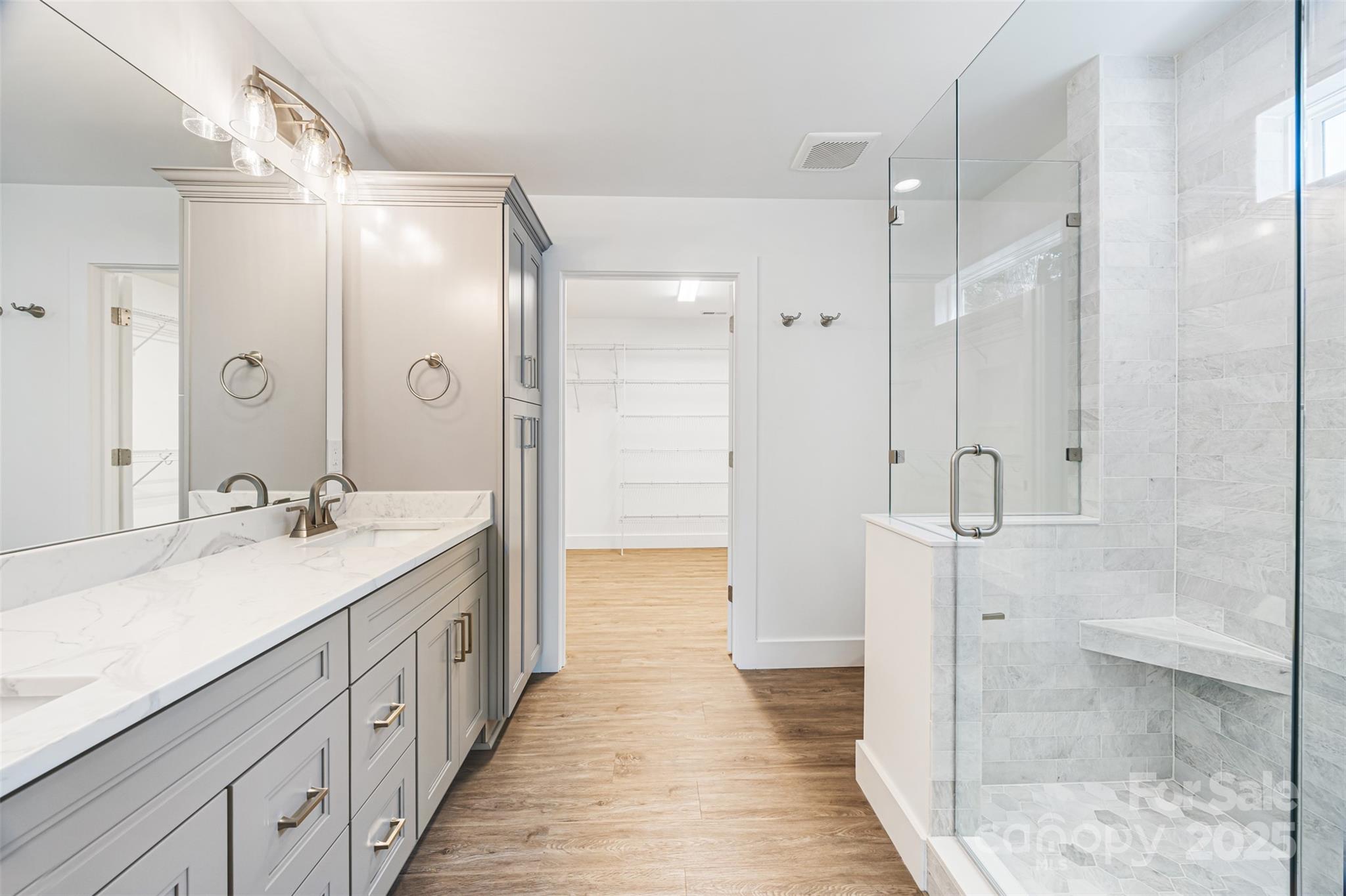 2027 Marquesas Avenue Tega Cay, SC 29708 - Photo 18 of 46 a spacious bathroom with a double vanity sink mirror and shower