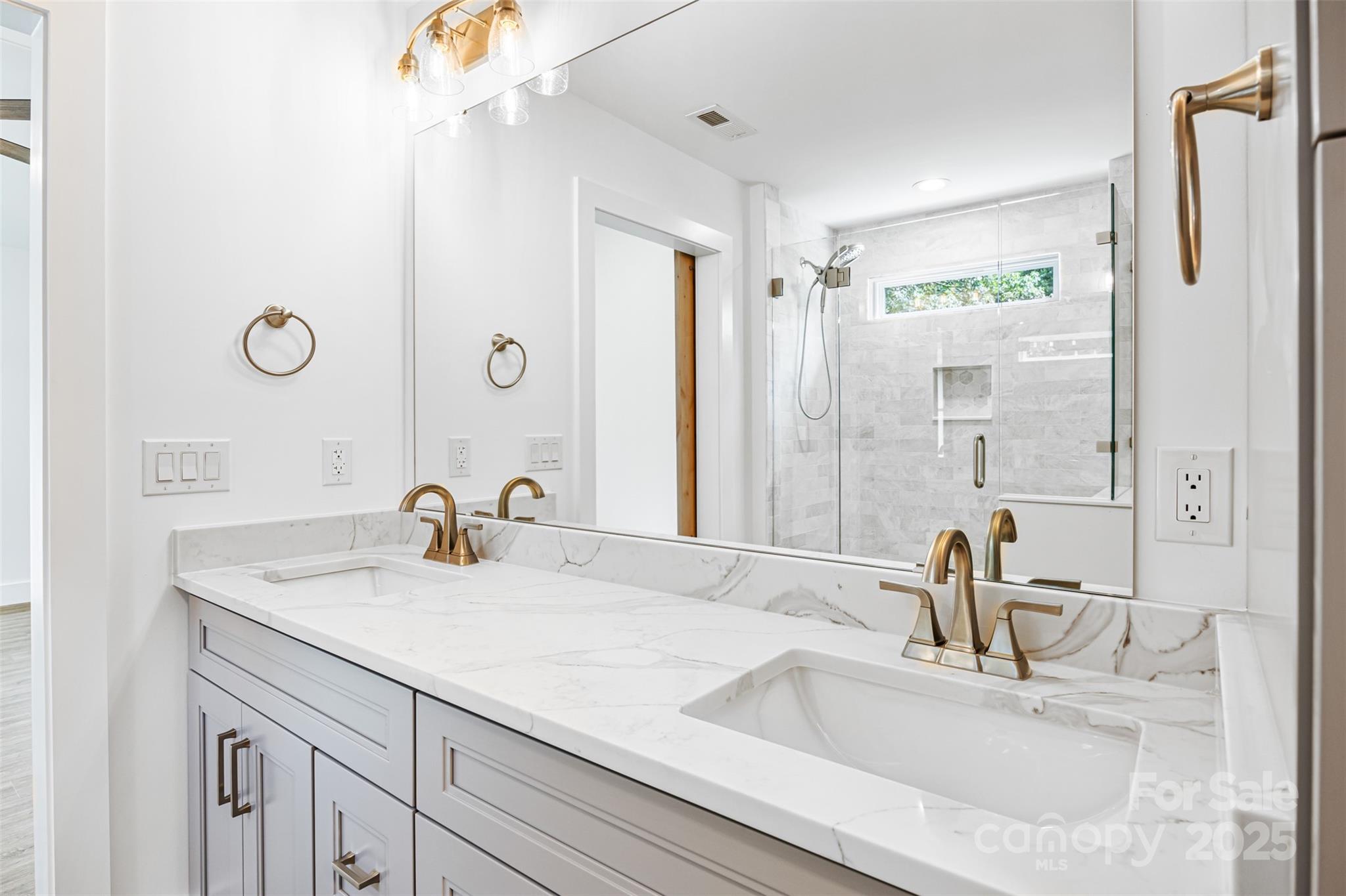 2027 Marquesas Avenue Tega Cay, SC 29708 - Photo 19 of 46 a bathroom with a sink and a mirror