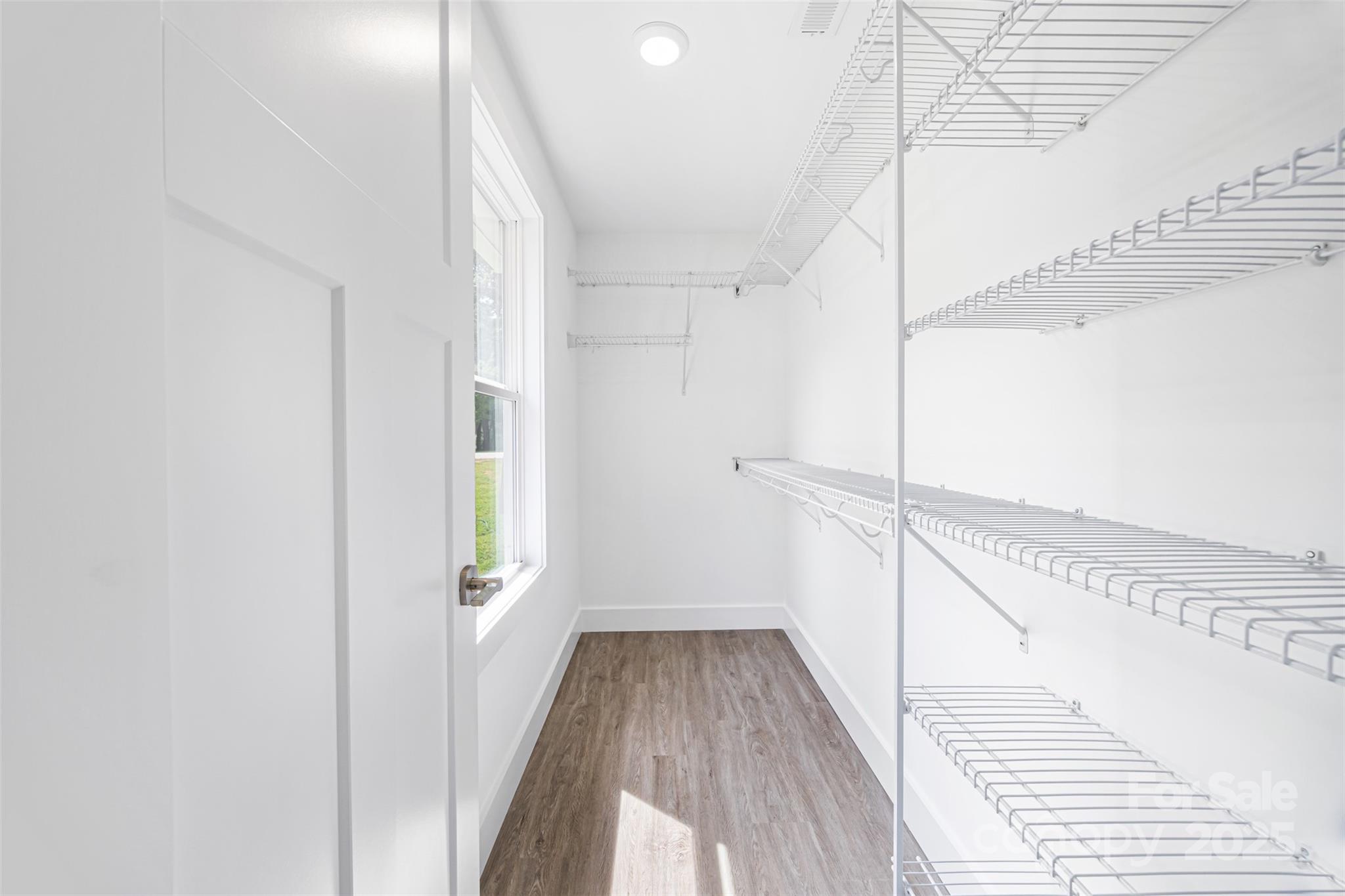 2027 Marquesas Avenue Tega Cay, SC 29708 - Photo 23 of 46 a view of a hallway with wooden floor and staircase
