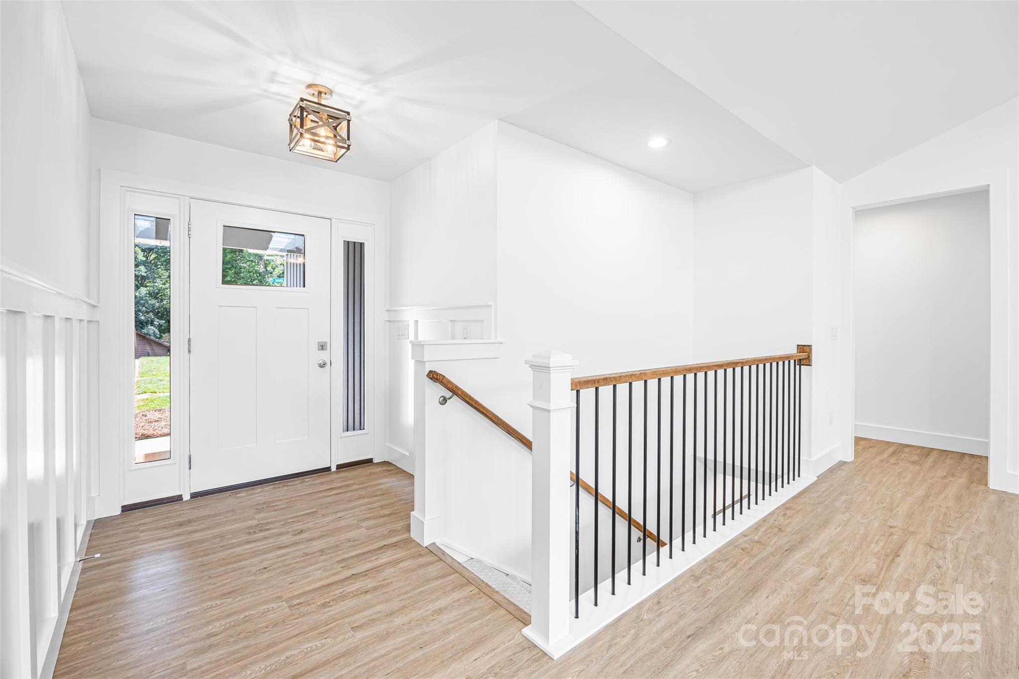 2027 Marquesas Avenue Tega Cay, SC 29708 - Photo 25 of 46 a view of a hallway with wooden floor and windows