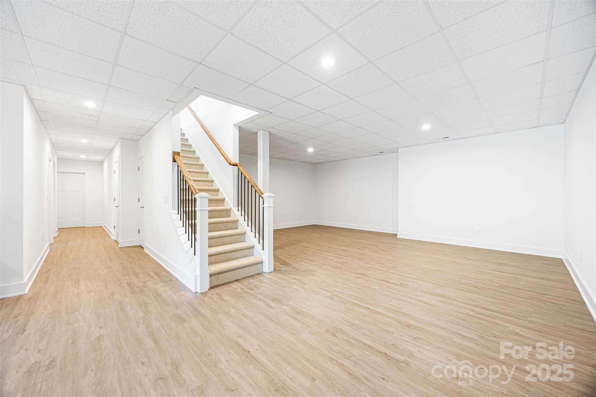 2027 Marquesas Avenue Tega Cay, SC 29708 - Photo 27 of 46 a view of a room with wooden floor and white walls