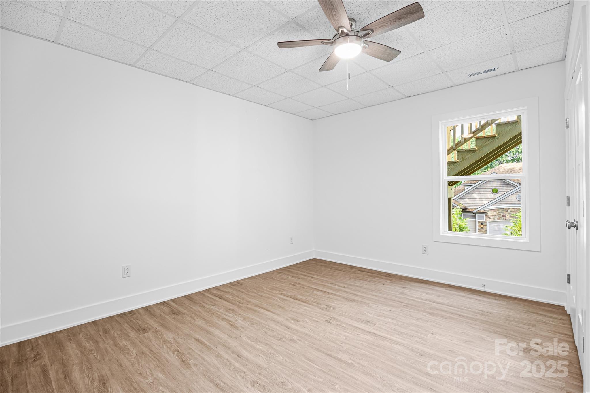 2027 Marquesas Avenue Tega Cay, SC 29708 - Photo 33 of 46 an empty room with a window and a ceiling fan