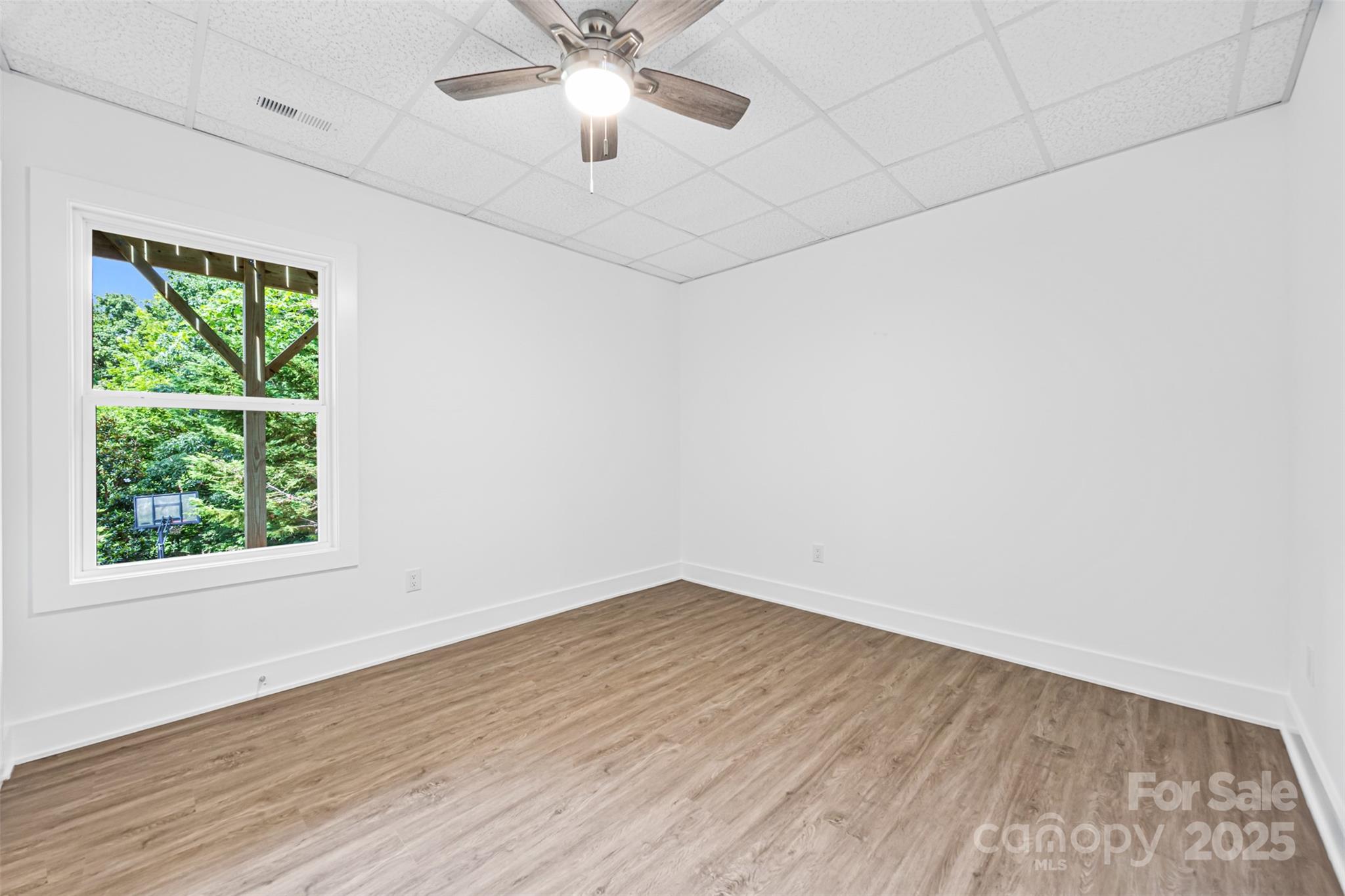 2027 Marquesas Avenue Tega Cay, SC 29708 - Photo 34 of 46 wooden floor in an empty room with a window
