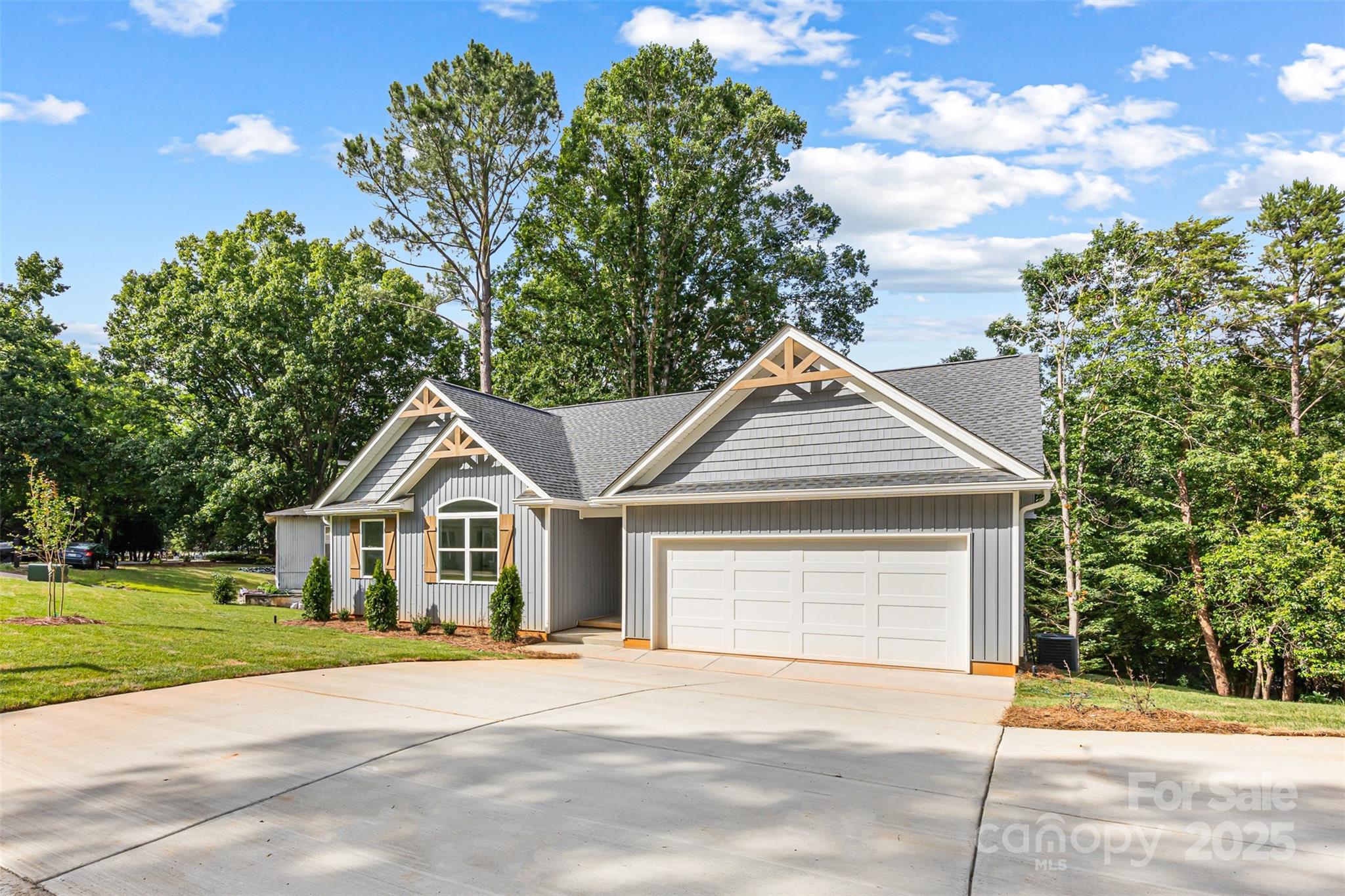 2027 Marquesas Avenue Tega Cay, SC 29708 - Photo 44 of 46 a front view of a house with a yard and garage
