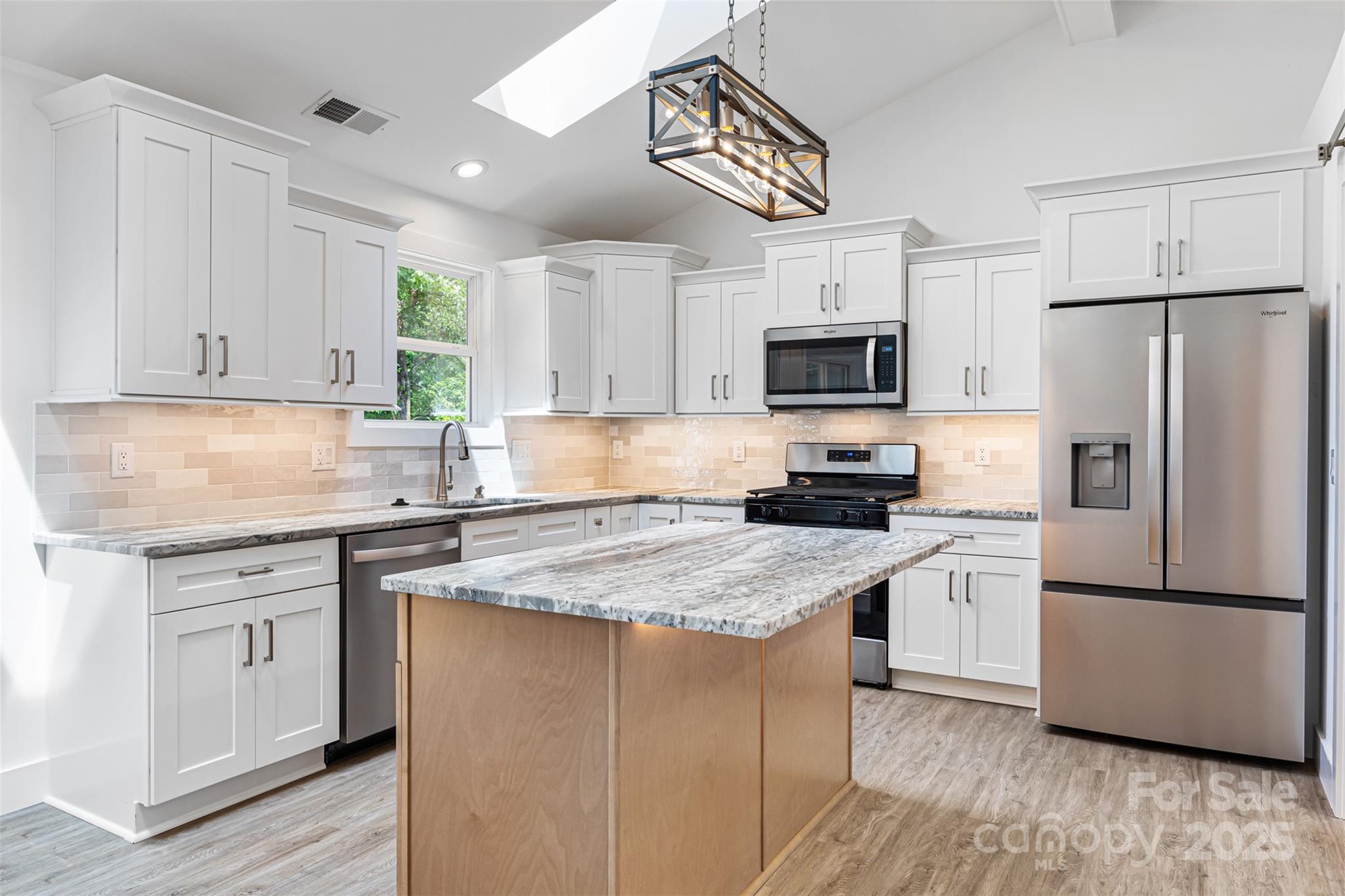 2027 Marquesas Avenue Tega Cay, SC 29708 - Photo 9 of 46 a kitchen with granite countertop a refrigerator stove top oven and sink